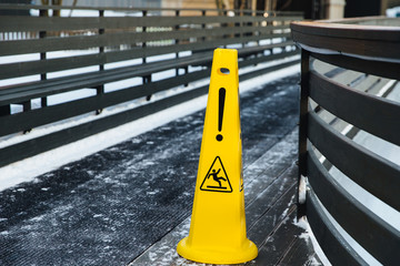 Be aware of slippery road. Slippery yellow surface sign. Wet floor sign. Icing concept. Selective focus. Slippery slope. Watch your step, please
