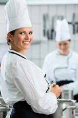Female chefs at work in industrial kitchen of canteen 