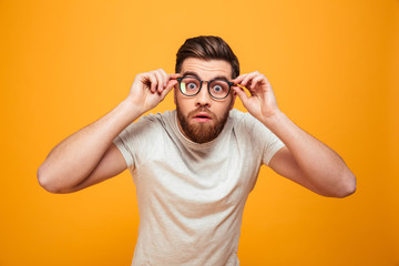 Portrait of a shocked bearded man in eyeglasses