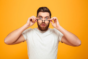 Portrait of a surprised bearded man in eyeglasses
