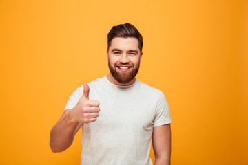 Portrait of a happy bearded man showing thumbs up