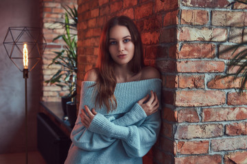 A sensual brunette in a gray sweater