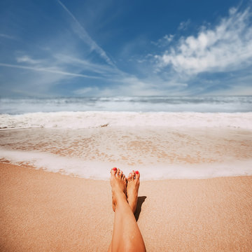 Female feet on sandy ocean  beach. picture with soft focus and place for your text. summer concept
