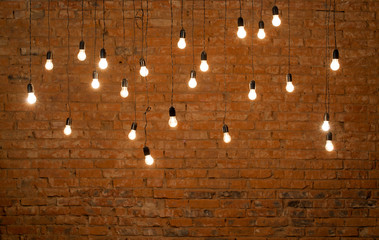 Light bulbs in a room made of bricks shining