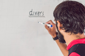 diver writes a marker on the board