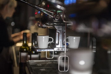 eine espressotasse steht auf einer modernen espressomaschine