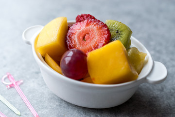 Mini Fruit Salad with Strawberry, Kiwi, Mango and Grape in White Ceramic Bowl.