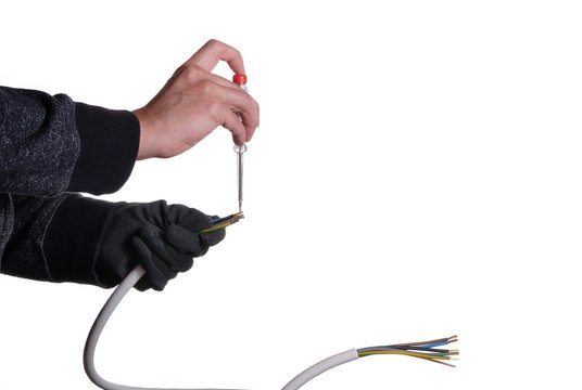 Ein Mann prüft mit einem Spannungsprüfer die Leitung auf das Vorhandensein von Strom