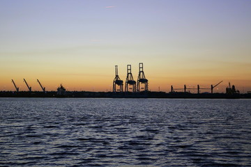 Obraz premium Port cranes in Jacksonville from across the St. Johns River