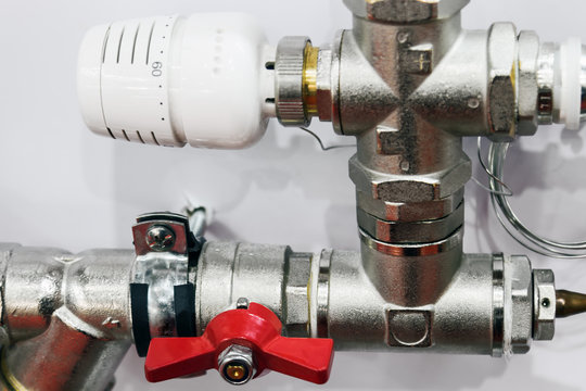 fittings and valve, pipes and adapters. Plumbing fixtures and piping parts. focus on the red crane
