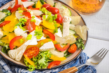 Salad with cheese and fresh vegetables.