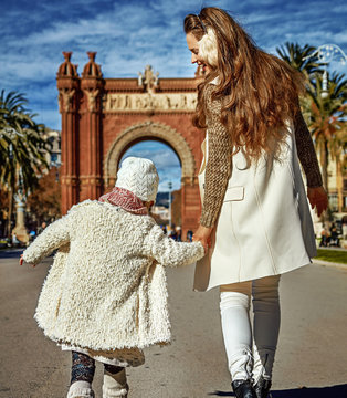 modern mother and daughter in Barcelona, Spain walking