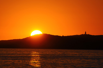 Naklejka na ściany i meble Sunset over the island Illa sa Conillera in Ibiza Spain