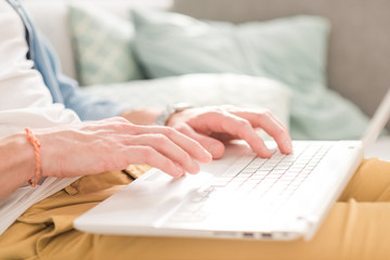 young Man sitting in sofa and using laptop