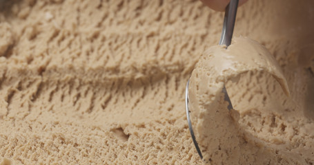 closeup hazelnut praline ice cream scooping with spoon