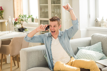 young Man sitting in sofa and using laptop