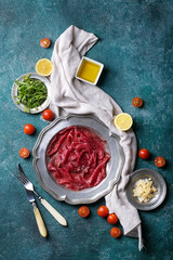 Fresh beef carpaccio with tomatoes