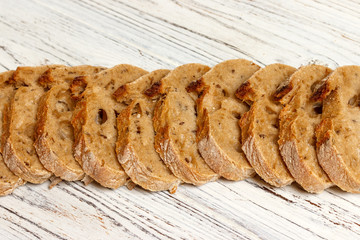 french bread baguette on cutting board with its slices