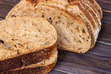 Sliced black bread on wooden table close-up