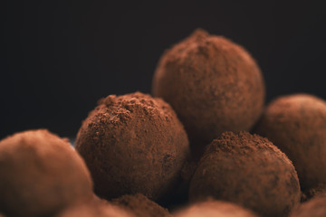 chocolate truffle balls on white plate closeup