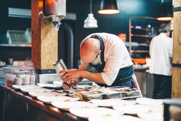 Cook serving dishes in restaurant