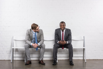 multiethnic businessmen in suits waiting for job interview