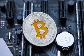 Bitcoin. New virtual money. Silver Bitcoins lie on the video card, concept of mining. Blockchain and mining concept.