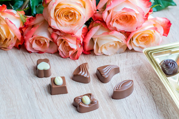sweets and roses on wooden table for gift