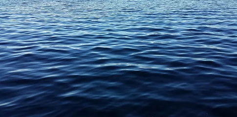 Fotobehang Blue water panorama background with soft waves  © natalya2015
