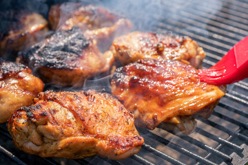 Grilled chicken thigh on the flaming grill © azurita