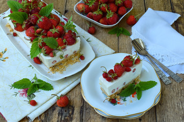 Cheesecake with berries, bio homemade strawberries from garden, delicious and simple cake on wooden background. Copy space for your text.