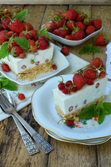 Cheesecake with berries, bio homemade strawberries from garden, delicious and simple cake on wooden background. Copy space for your text.