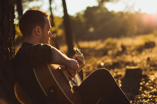 Man playing guitar in nature