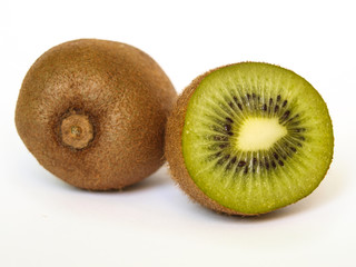 Complete and halved kiwi on white isolated background. South China's national fruit.