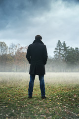 the man is standing in the field