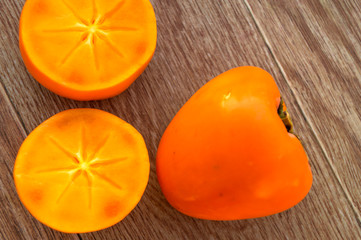 Ripe persimmons on the wooden table