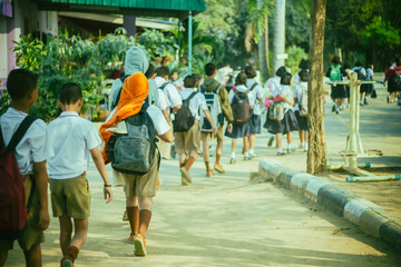 Happy students having fun on street after school