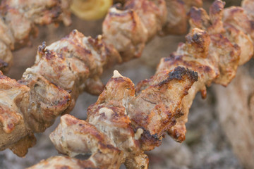 Mutton shish kebabs on skewers on the grill outdoors
