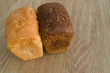 White and black bread on a wooden table