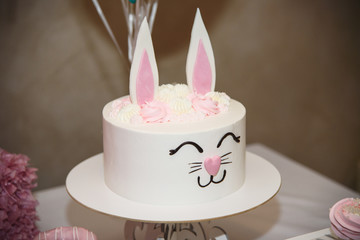 sweet white children's cake in the form of a rabbit