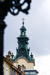 Fototapeta na wymiar Closeup Old Dark Green Catholic Church Bell Tower