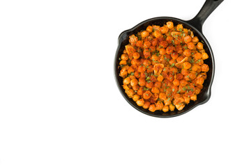 Fried spicy chickpeas in frying pan isolated on white background. Top view copyspace