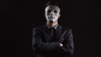 Anonymous man in business suit folding hands, masking personality, hiding income