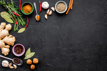 Gastronomy, culinary. Secrets of tasty dishes. Seasoning and spices. Rosemary, ginger, chili pepper on black background top view copy space