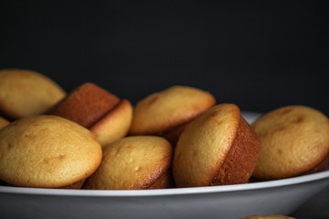 small muffins (cupcakes) - fresh pastries on a wooden surface