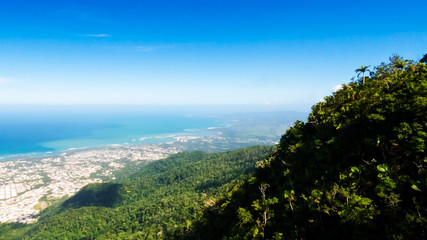 Fototapeta na wymiar An amazing view of Puerto Plata, the Atlantic Ocean and a lot of tropical trees from the top of Mount Isabel de Torres, Dominican Republic.