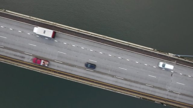 CARS GOING OVER A BRIDGE OVER WATER