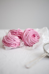 Obraz na płótnie Canvas Homemade pink zephyr or marshmallow on white background