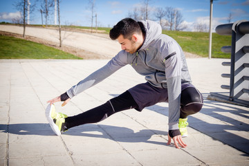 Young athletic man is preparing before running.