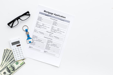 Mortgage application near house sign and money on white background top view copy space